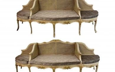 A PAIR OF LOUIS XV STYLE PAINTED AND CANED PARCEL GILT