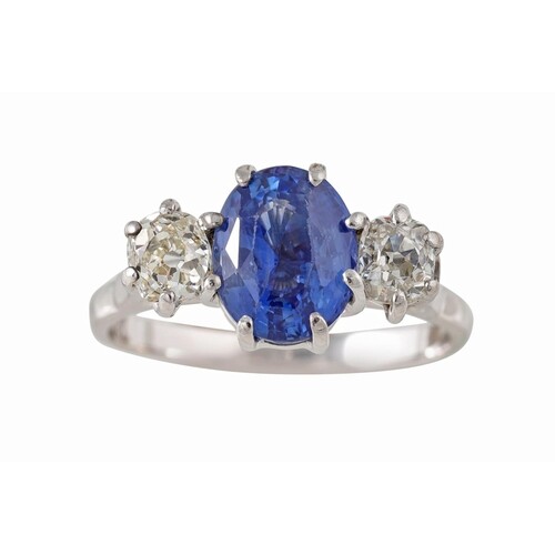 A SAPPHIRE AND DIAMOND THREE STONE RING, the oval sapphire f...
