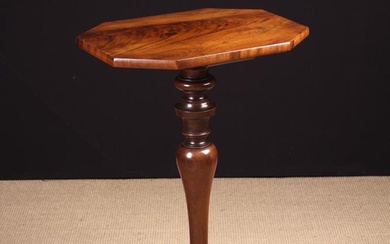A Small 19th Century Mahogany Pedestal Table. The canted rectangular flame figured top on a knopped