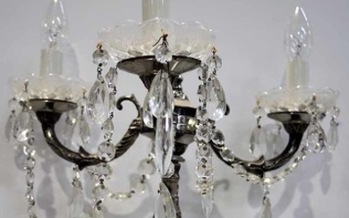 A THREE BRANCH CANDELABRA WITH CRYSTAL DROPS