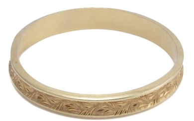 A VINTAGE 14CT GOLD BANGLE; 10.6mm wide hollow bangle of concave form with engraved decoration and Austro Hungarian hallmarks, inter...