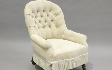 A Victorian tub back salon armchair with buttoned taupe upholstery, on turned legs and castors, heig