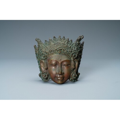 A bronze mask of a female deity, Tibet or South East Asia, 1...