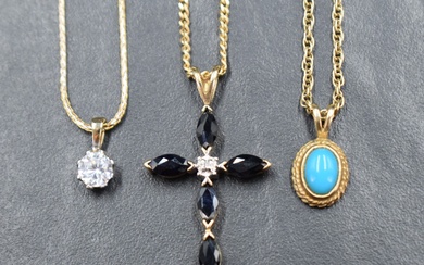 A collection of three pendants with chains comprising a 9ct gold sapphire and diamond cross on a 9ct