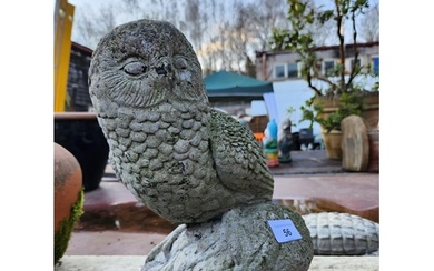 A concrete composite owl garden ornament.