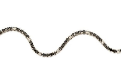 A diamond and black diamond line bracelet, composed of a single row of circular-cut black diamonds interspersed with brilliant-cut diamond spacers, approx. length 18.5cm Please note that the black diamonds have not been tested for natural colour...