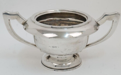 A filled silver twin handled trophy cup, Chester, 1911, E J Trevitt & Sons, on circular foot, 14cm high, 28.5cm wide