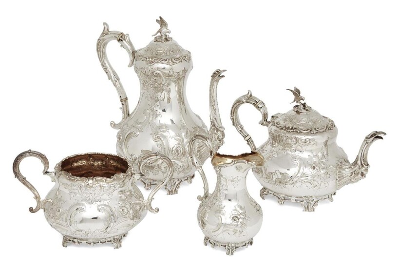 A four piece Victorian silver tea service, Sheffield, 1856 (coffee pot), 1864 (teapot), sugar and milk (both 1866), Martin, Hall & Co., designed with repousse floral scroll bodies, the teapot and coffee pot with silver foliate scroll handles with...