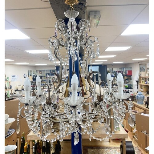 A gilt metal cut glass and lustre hung seven light chandelie...