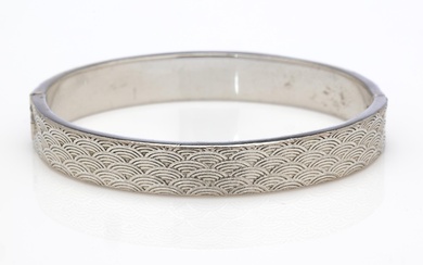 A good vintage heavy sterling silver bangle, 41.8g, embossed to both sides with a continuous band of waves, inner W: 62mm