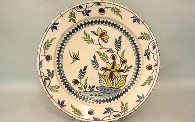 A mid 18th century Bristol delft charger decorated with