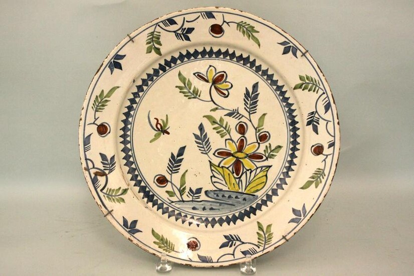 A mid 18th century Bristol delft charger decorated with