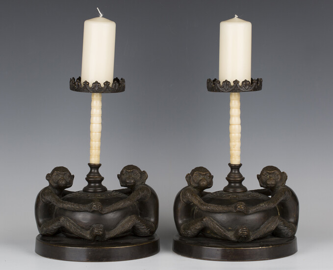 A pair of 20th century South-east Asian brown patinated cast bronze pricket candlesticks, each folia