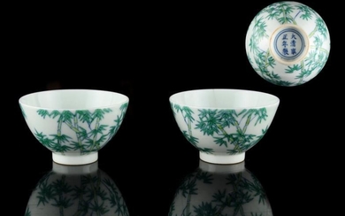 A pair of Chinese doucai wine cups, each painted...