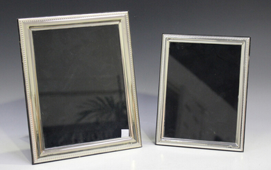 A pair of Elizabeth II silver mounted graduated rectangular photograph frames with beaded borders, L
