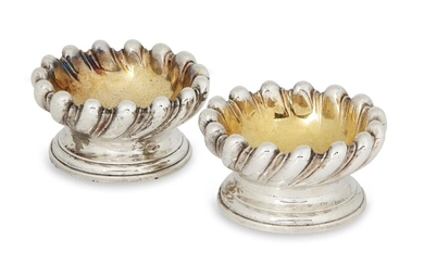 A pair of George IV silver salts, London, c.1828, Richard Sibley II, bases stamped 'Makepeace London', of fluted spiral design with gilded interiors and stepped circular feet, engraved with matching leopard crests, total weight approx. 14.8oz (2)