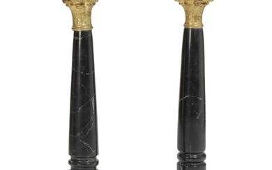 A pair of blackish marble pedestals with bronze mountings. 20th century. H. 93. L. 27. W. 27 cm. (2)