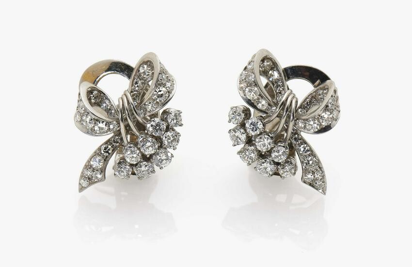 A pair of bow-shaped stud earrings with brilliant cut
