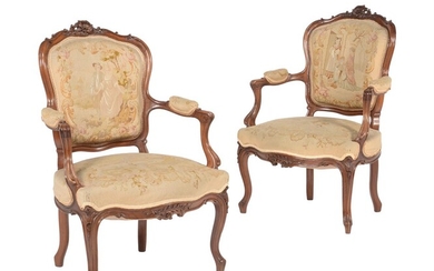 A pair of carved walnut armchairs in Louis XV style