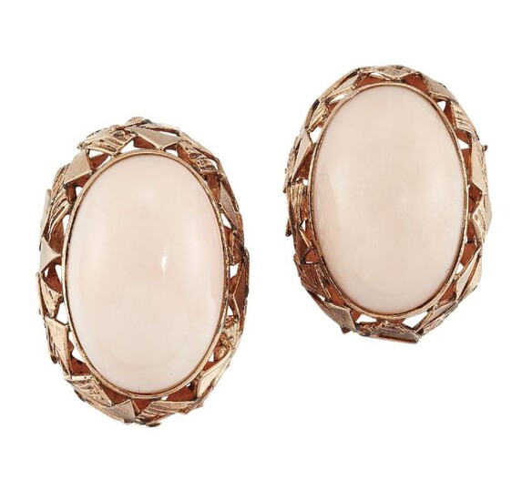 A pair of coral earclips, each oval...