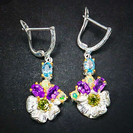 A pair of ear pendants each set with numerous oval and circular-cut amethysts, peridots and topazes, mounted in rhodium and gold plated sterling silver. (2)