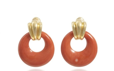 A pair of gold ear clips with interchangeable hoops