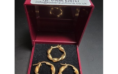 A pair of hallmarked 9ct yellow gold earrings with a rope tw...
