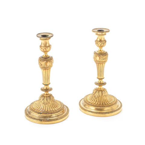 A pair of late 19th century French gilt bronze candlesticks in the Louis XVI style