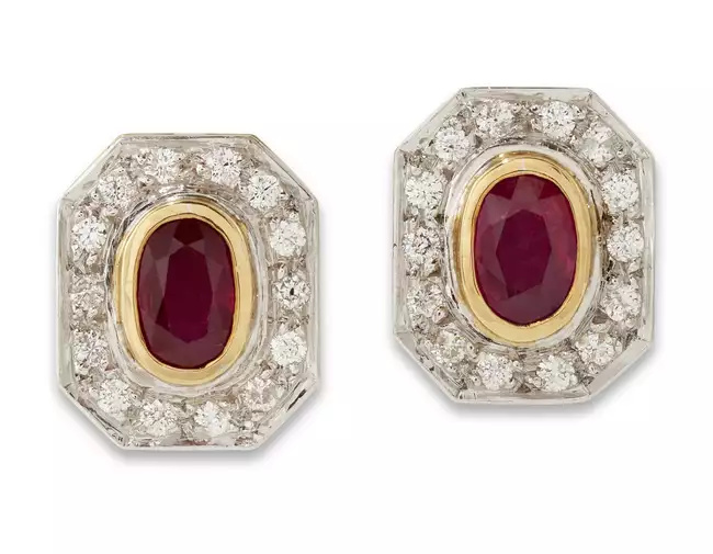 A pair of ruby and diamond earrings, the oval mixed-cut...