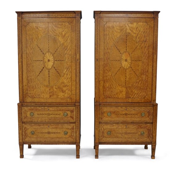 A rare pair of George III satinwood and marquetry inlaid cabinets, the burr walnut crossbanded top above single cupboard door inlaid with central fan patera and harebells to border, enclosing three adjustable shelves, the base section with two...