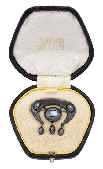A silver and hematite Jugenstil brooch by Theodore Fahrner, of horseshoe design set with hematite cabochons, gold brooch pin to reverse, TF Depose and FM monogram, c. 1903, later Tadema Gallery fitted case.