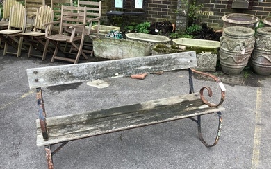 A slatted wrought iron garden bench, width 147cm, height 74c...