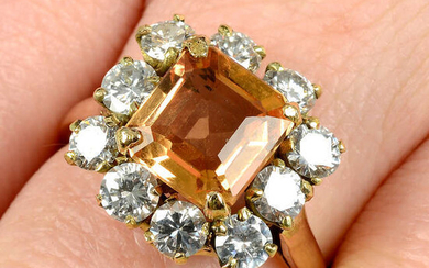 An orange topaz and brilliant-cut diamond cluster ring.