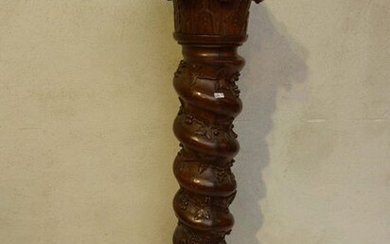 A twisted column in dark oak carved with branches and vines (from pamphlets to Corinthian capitals in Renaissance style).