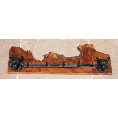 A wall mounted cast iron and yew wood hat/coat rack, the rou...