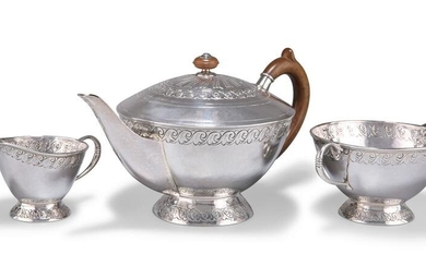 AN ARTS AND CRAFTS SILVER THREE-PIECE TEA SERVICE, by