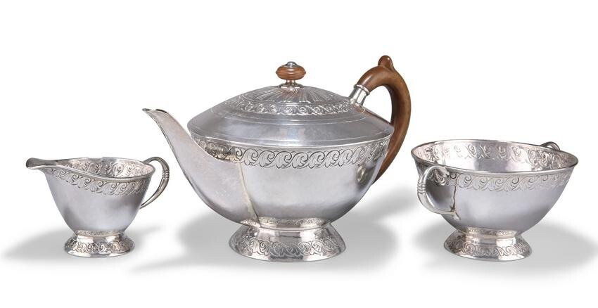 AN ARTS AND CRAFTS SILVER THREE-PIECE TEA SERVICE, by