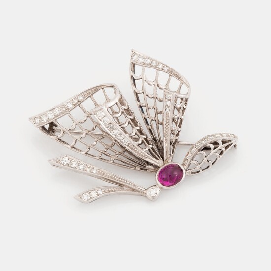 An 18K white gold brooch set with a cabochon-cut ruby and eight-cut diamonds