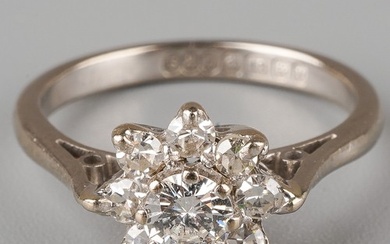 An 18ct white gold and diamond cluster ring, set with a roun...