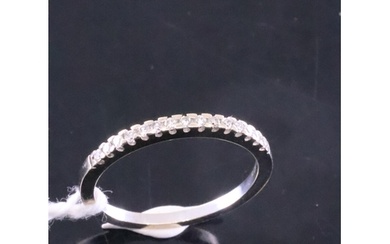 An 18ct white gold diamond set eternity ring, showing as siz...