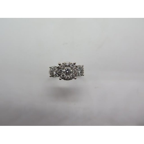 An 18ct white gold hallmarked diamond triple cluster ring, t...