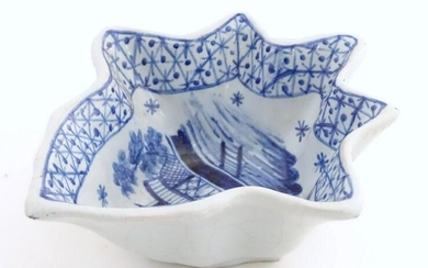 An 18thC Delft blue and white pickle dish of vine leaf