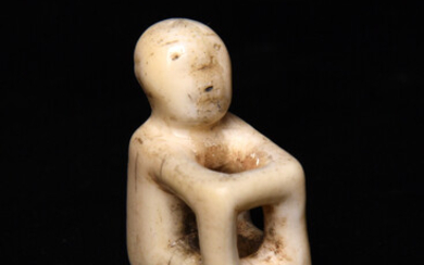 λ An Aleutian seated figure amulet