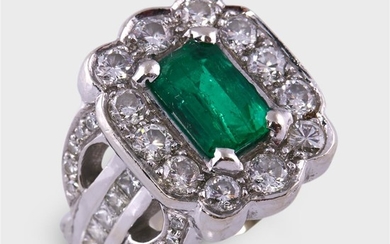 An emerald, diamond, and platinum ring designed as a...
