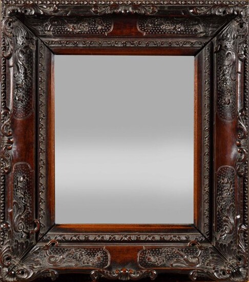 Carved exotic wood mirror decorated with foliage on a dotted background, palmettes and flowers. (a frame originally, glass brought back at a later date). Probably Portuguese Indies, 18th century. H : 47 cm, W : 42 cm