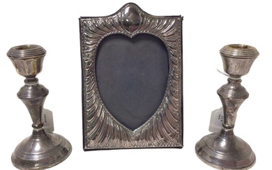 Contemporary silver photograph frame, with embossed decoration and a pair of candlesticks