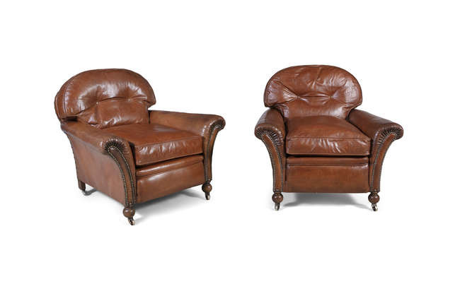 Description A PAIR OF BROWN LEATHER UPHOLSTERED CLUB ARMCHAIRS,...