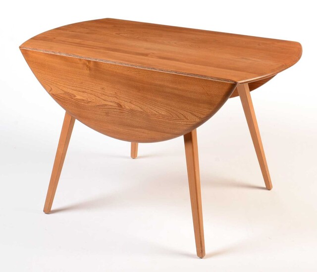 Ercol: a light beech and elm round-shaped drop-leaf dining table.