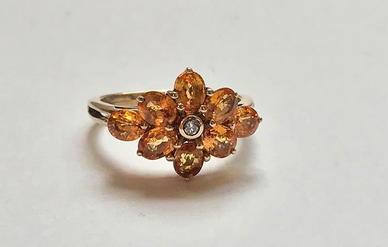 Large orange sapphire and diamond cluster ring, on 9ct yello...