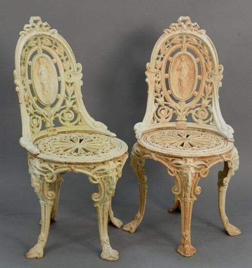 Pair iron outdoor chairs with medallion backs and rams